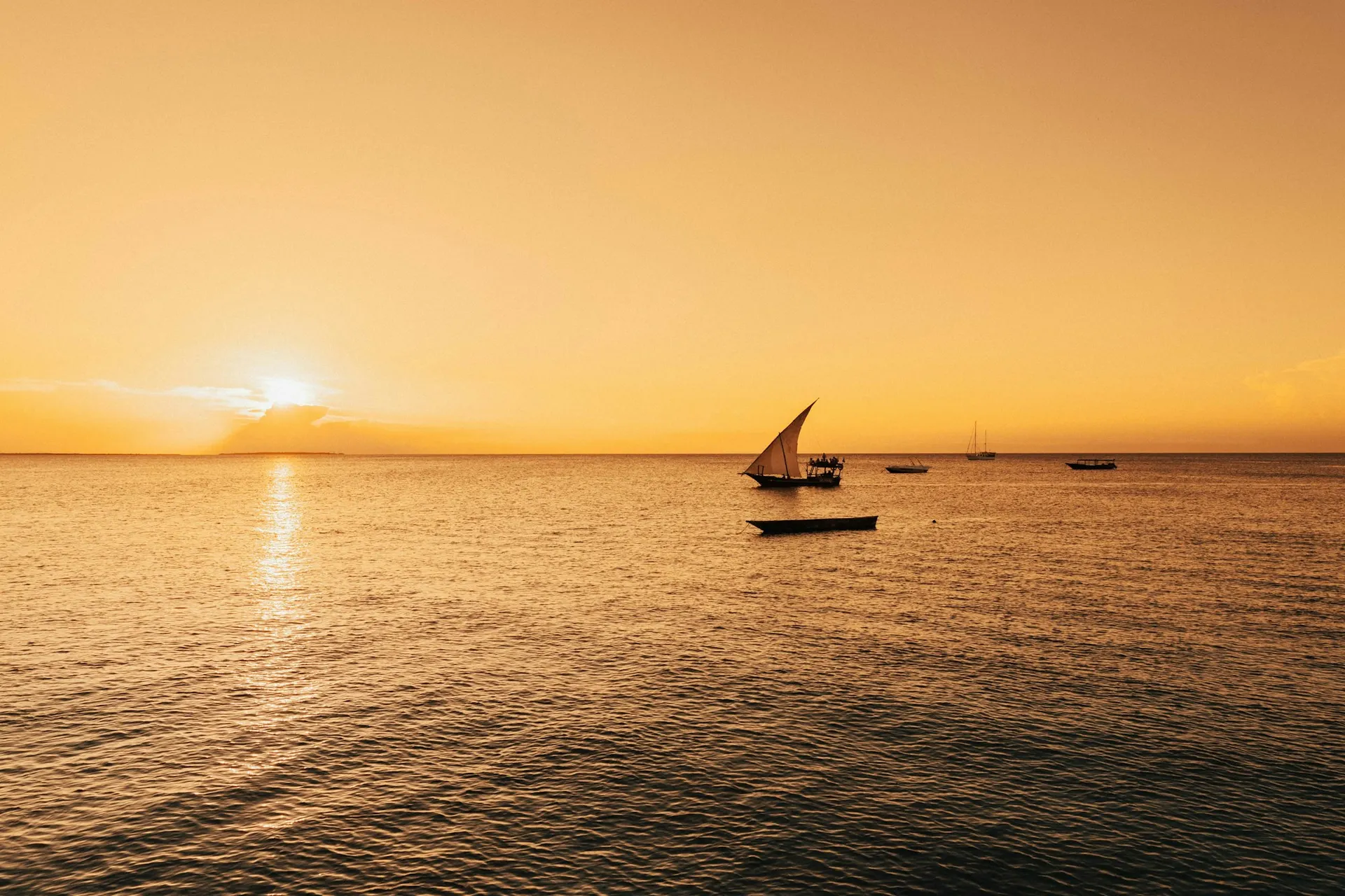Wide Zanzibar beach at sunset