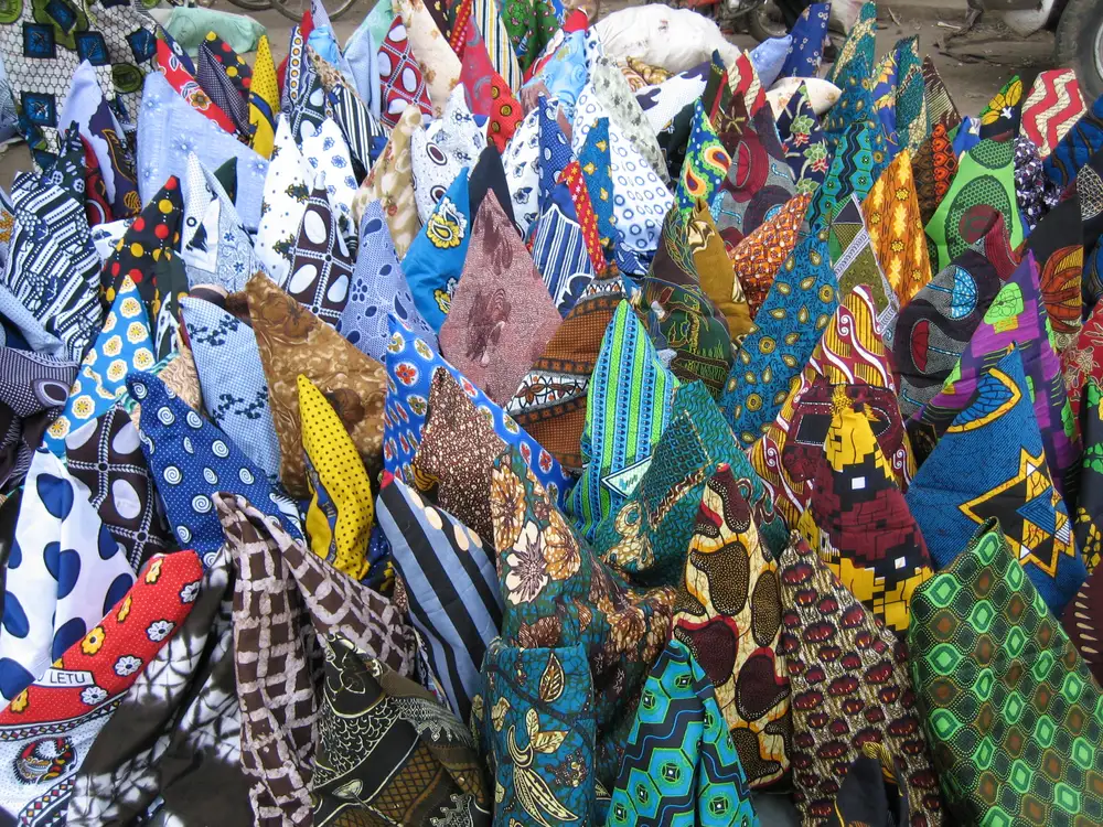 Colourful kanga and kitenge fabrics at a Tanzanian market stall